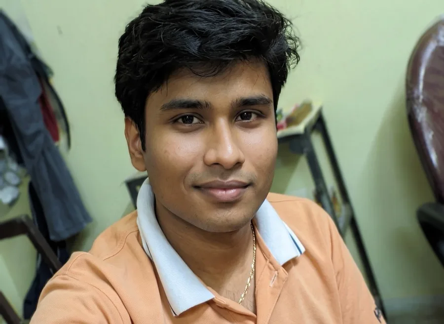 Lavi smiles at the camera in an orange polo during his NIT Raipur years.